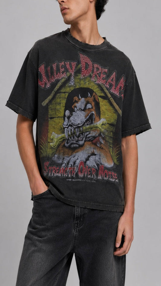 Person wearing a black t-shirt with graphic design and text on a gray background