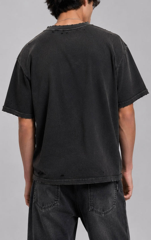 Person wearing a black t-shirt and pants on a gray background