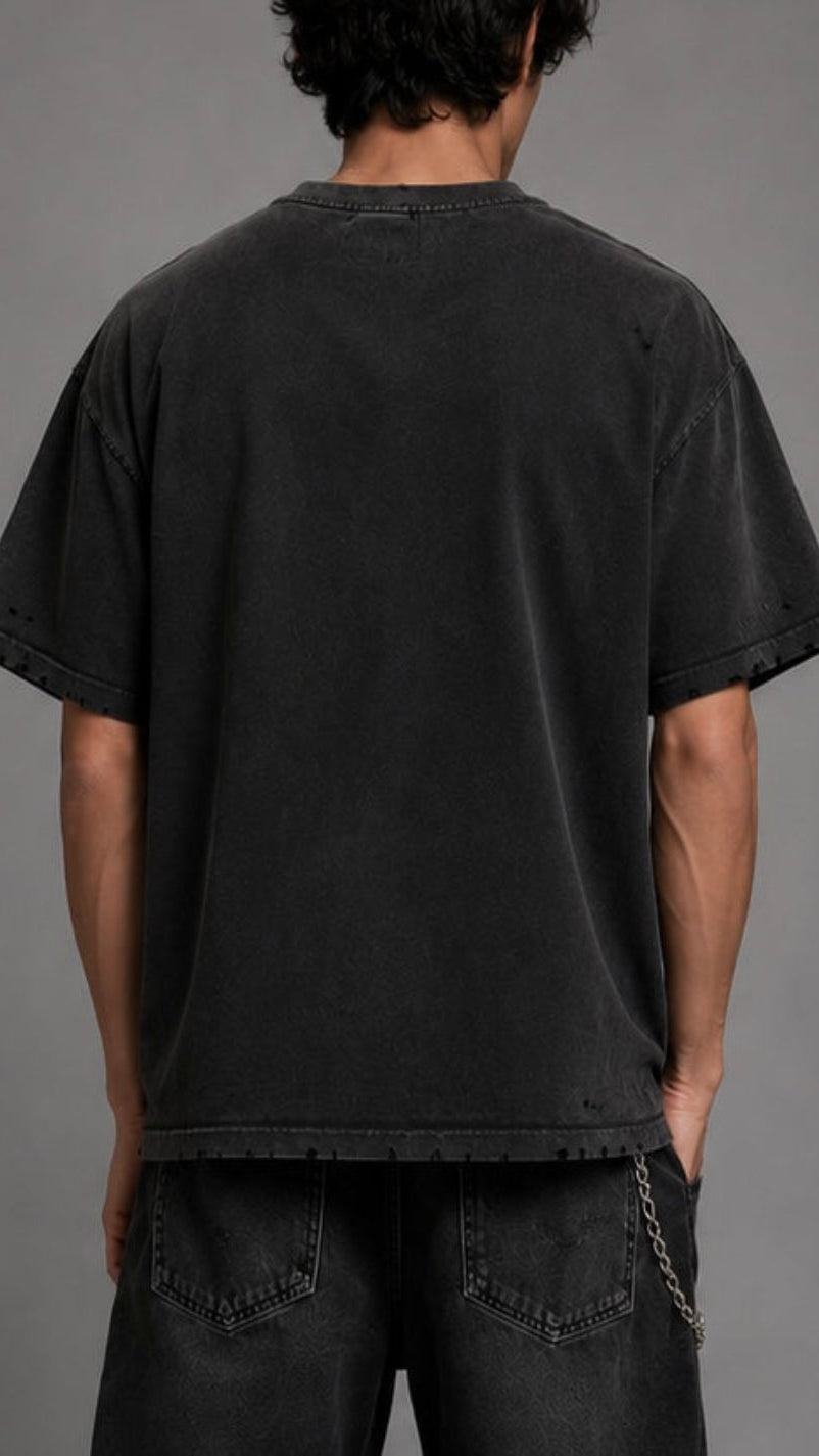 Person wearing a black t-shirt and pants against a gray background