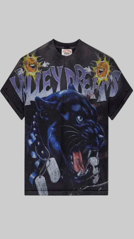 A black short-sleeve t-shirt featuring a large graphic print of a roaring black panther, stylized purple 'VALLEY DREAMS' text across the chest, and yellow sunburst graphics near the shoulders.