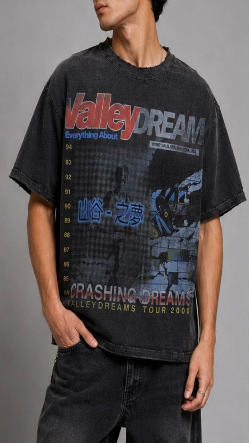 Person wearing a black t-shirt with graphic design and text on a gray background