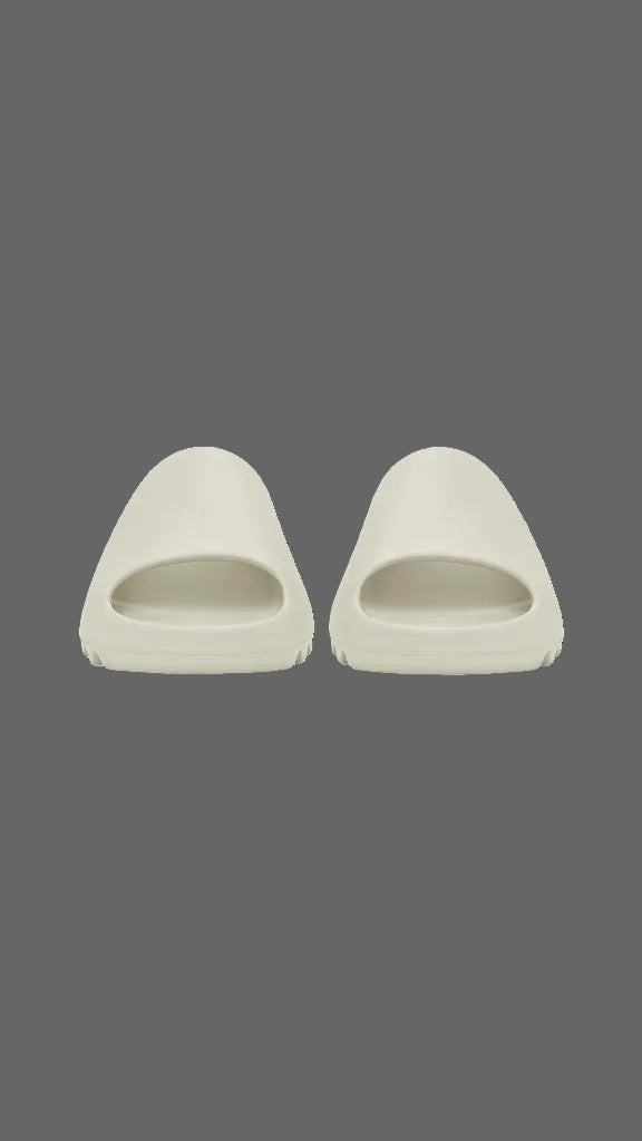 Pair of beige slides on a grey background