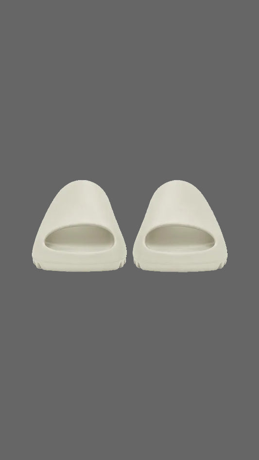 Pair of beige slides on a grey background