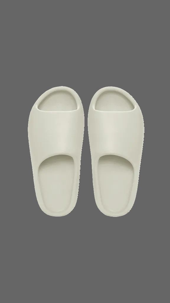 Pair of white slippers on a dark grey background