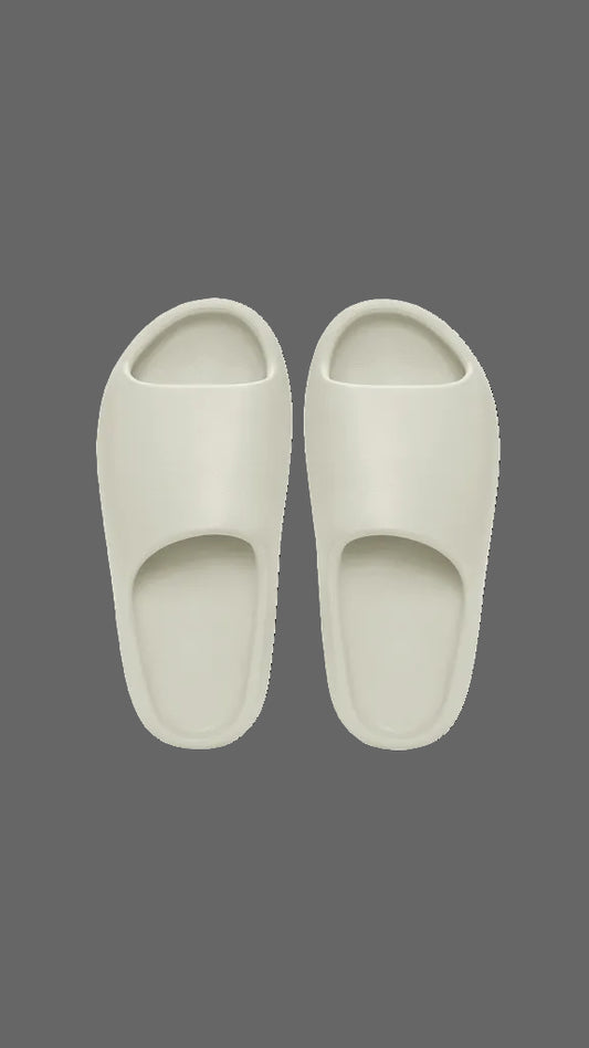 Pair of white slippers on a dark grey background